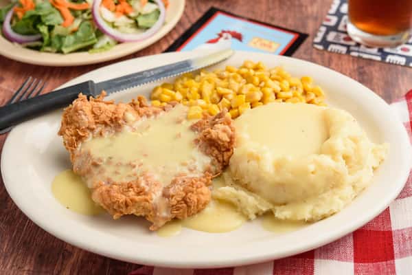 Fried Chicken with mashed potatoes and corn topped with gravy