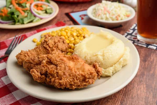 Fried Chicken with mashed potatoes and corn topped with gravy