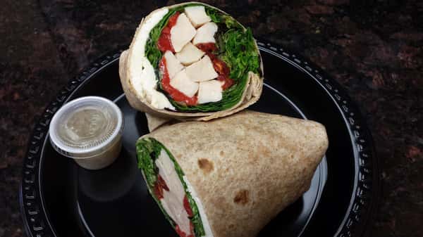 Whole wheat wrap with chicken, lettuce, tomato, and cheese
