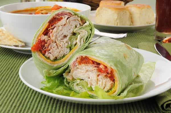 Spinach wrap with turkey cheese, lettuce, and tomato