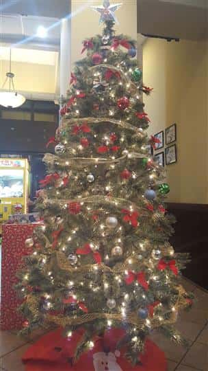 Christmas Tree decorated with other Christmas decorations in the back
