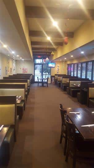 Dining area of the establishment with windows in the background