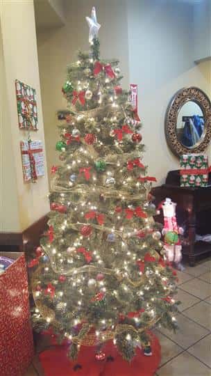 Christmas Tree decorated with other Christmas decorations in the back
