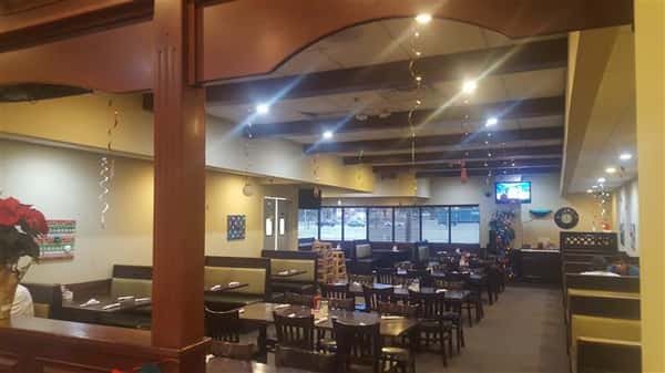 Dining area of the establishment with windows in the background