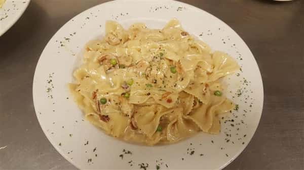 Fettuccine served on a platter with peas