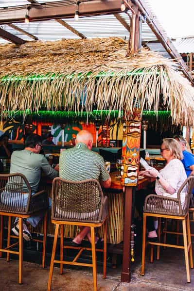 OHSO Paradise Valley Tiki Bar. People sitting at bar.