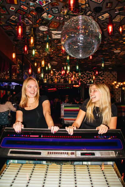 Two women standing in front of disco ball at private event at OHSO Party House in Arcadia
