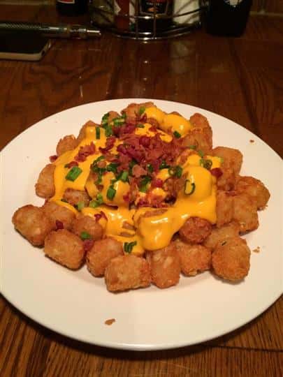 tater tots with melted cheese and bacon bits on top