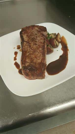 Steak on a plate with potatoes and gravy