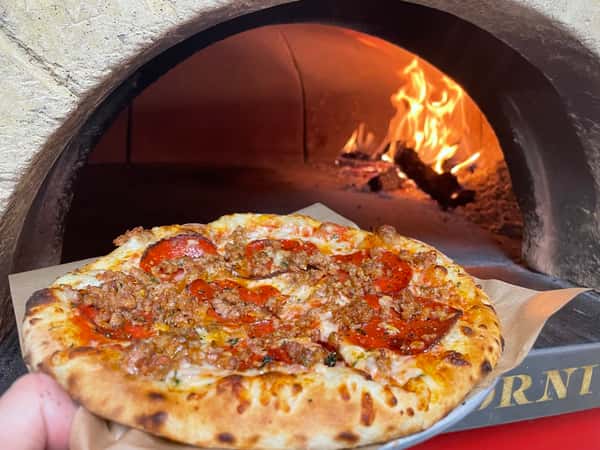 Pizza going into oven