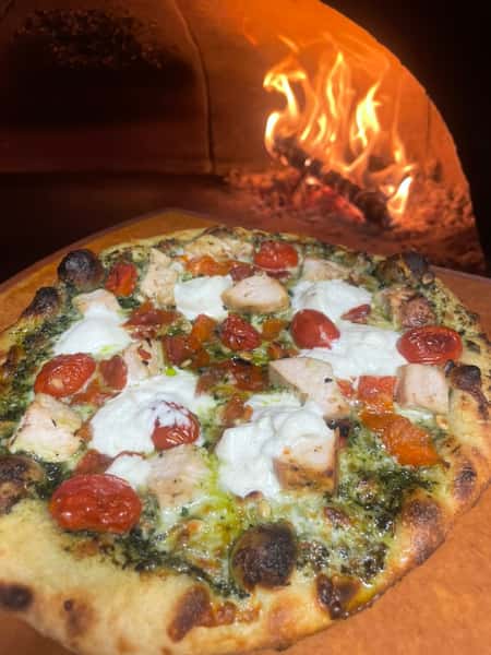 Pizza going into oven