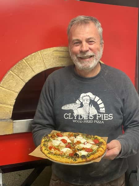 Owner with pizza