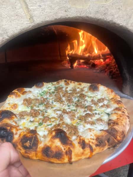 Pizza going into oven