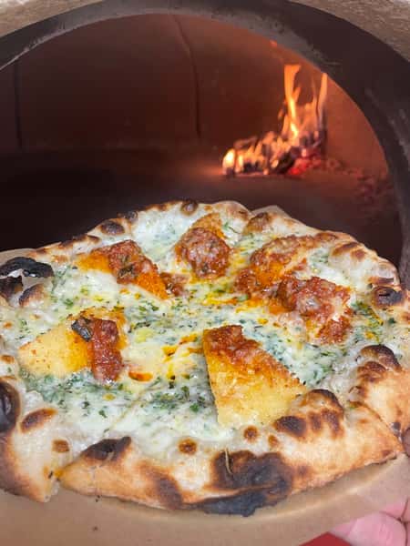 Pizza going into oven