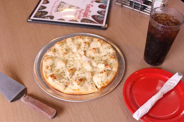 pizza pie with utensils and menu