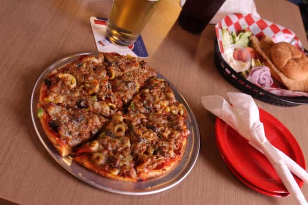 pizza pie with cola and beer with fried chicken sandwich