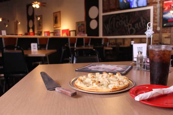 pizza pie with utensils and menu
