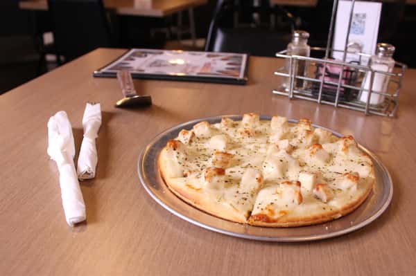 pizza pie with utensils and menu