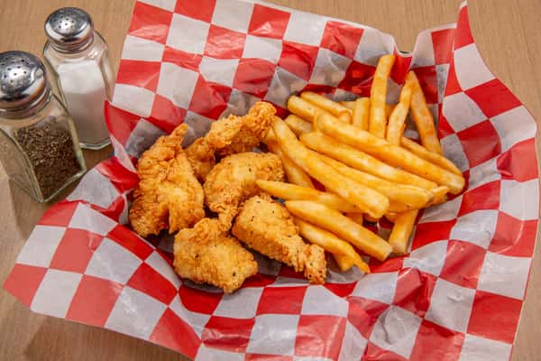 Crispy chicken bites with golden fries served at The Gaslight Pizza & Grill in Huntingburg, Indiana