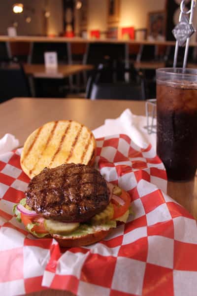 hamburger with cola in background