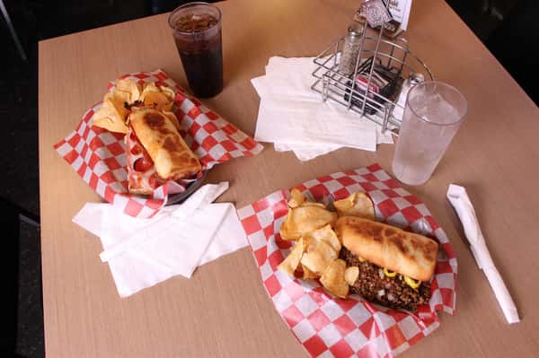 two sandwich basket with chips and cola