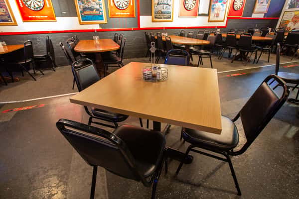 Restaurant seating area with tables and chairs in a relaxed dining space at The Gaslight Pizza & Grill in Huntingburg, Indiana