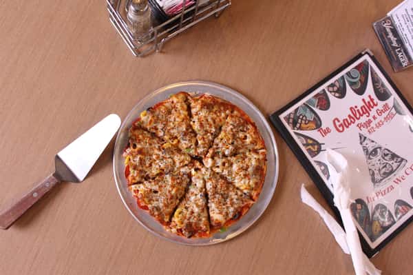 pizza pie with utensils and menu