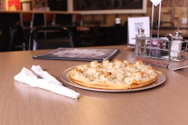 pizza pie with utensils and menu