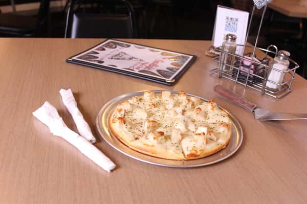 pizza pie with utensils and menu