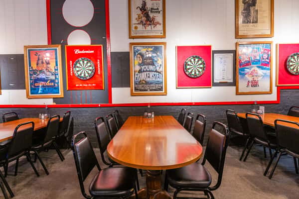 Long table seating with framed wall decor inside The Gaslight Pizza & Grill in Huntingburg, Indiana