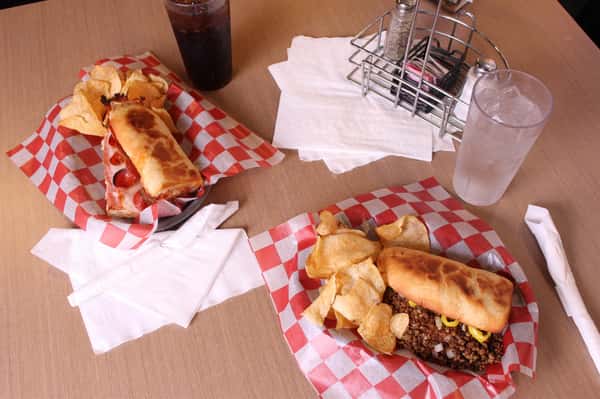 two sandwich basket with chips and cola
