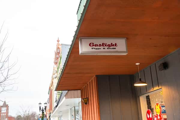 Exterior sign and entrance of The Gaslight Pizza & Grill in Huntingburg, Indiana