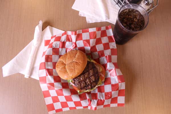 hamburger with cola in background