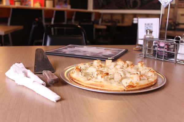 pizza pie with utensils and menu