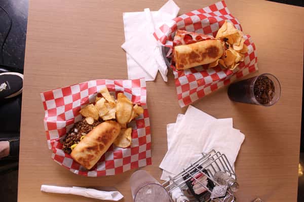 two sandwich basket with chips and cola