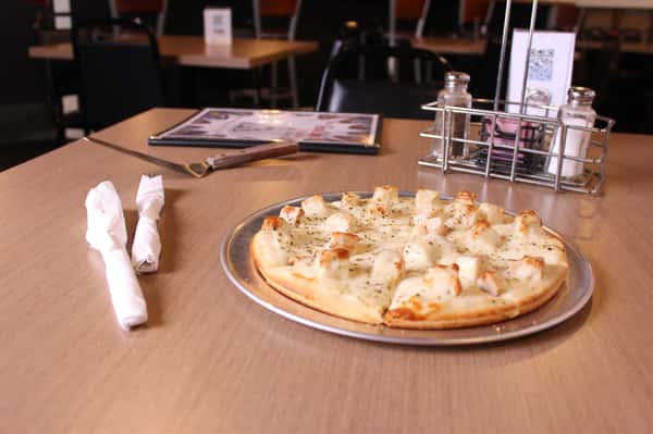 pizza pie with utensils and menu