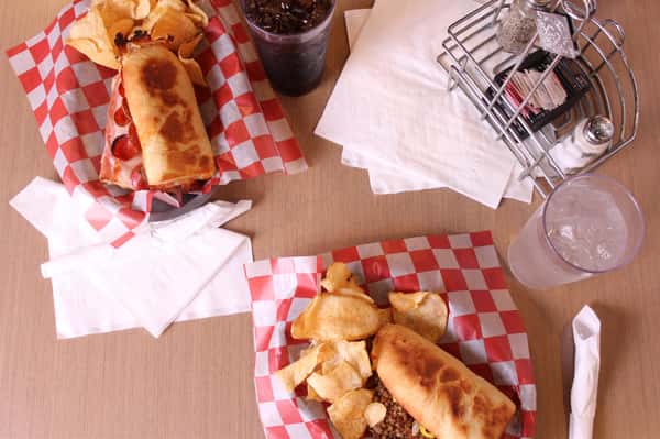 two sandwich basket with chips and cola