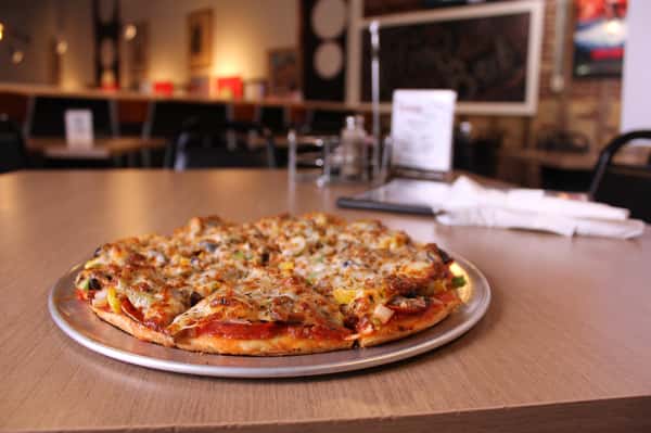pizza pie with utensils and menu