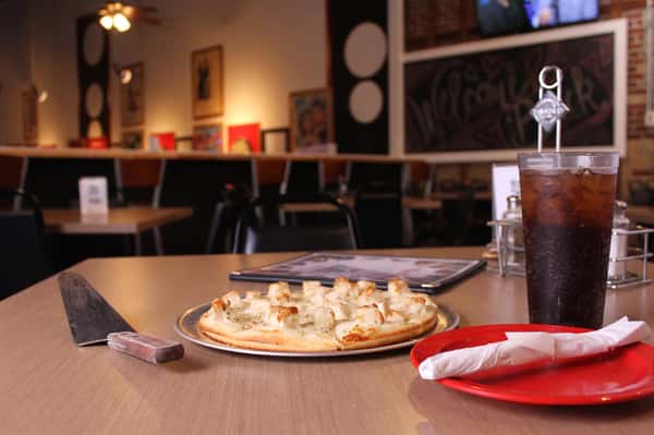 pizza pie with utensils and menu