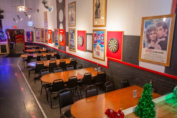 Casual dining area with framed artwork and table seating at The Gaslight Pizza & Grill in Huntingburg, Indiana