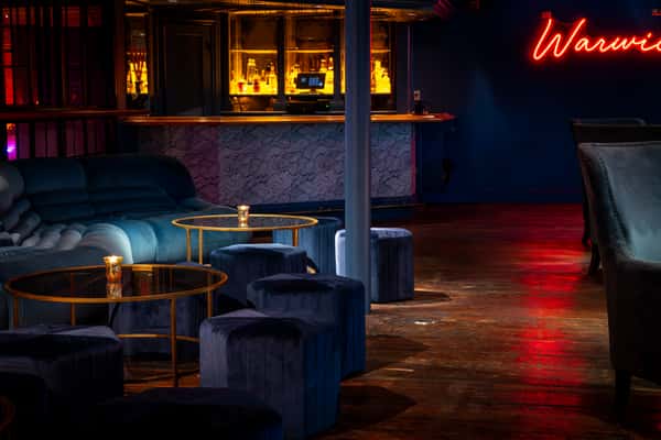 Green velvet plush seating in the VIP lounge