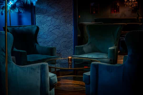 VIP area with low lighting and comfortable, stylish couches.