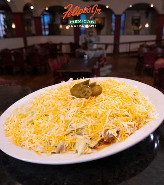 Mexican rice and refried beans topped with shredded cheese and jalapeños
