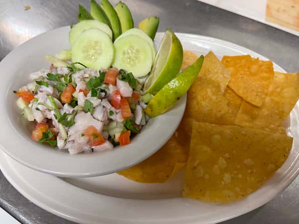Mexican chilaquiles served with rice, refried beans, and sliced avocado