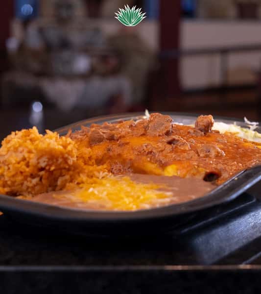 Cheese enchiladas covered in red sauce and served with Mexican rice