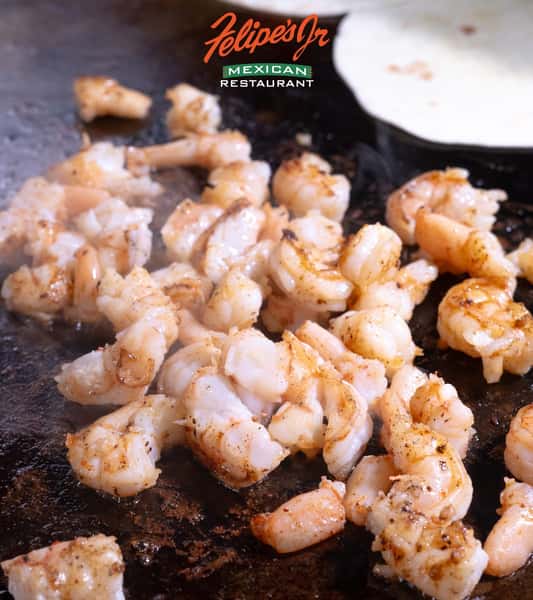 Close-up of seasoned grilled shrimp served hot at Felipe's Jr.