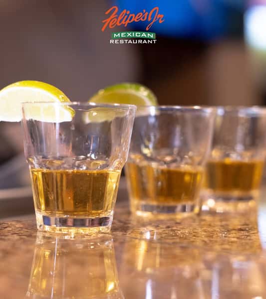 Tequila shots served with fresh lemon wedges