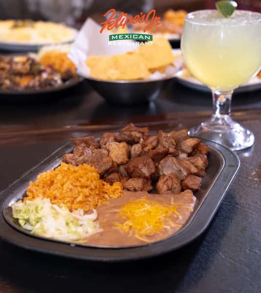 Bite-sized pieces of grilled steak served with Mexican rice