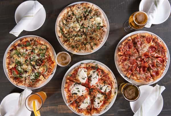 Top-view of four pizzas on a table