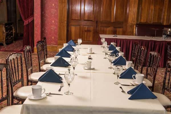 long table with napkins, plates, silverware